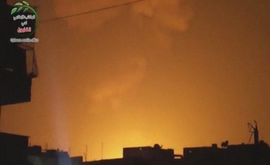 Glowing: The sky is lit up after an explosion at what Syrian state television reported was a military research centre in Damascus early today