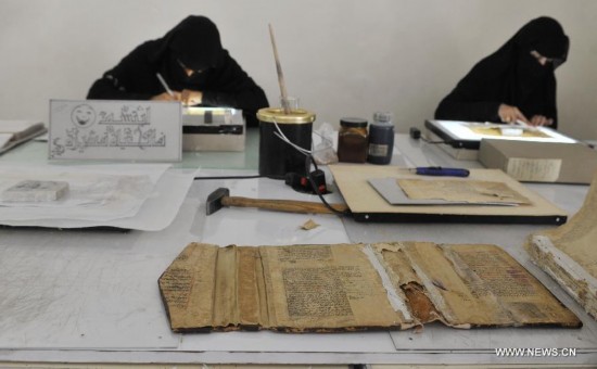 Yemeni experts restore manuscripts inside a repair center in Sanaa, Yemen, on June 2, 2014. Yemeni government began the restoration of the manuscripts in 1980. In the repair center, there are 16,000 ancient parchment fragments, some of which are among the oldest Quran manuscripts in the world.