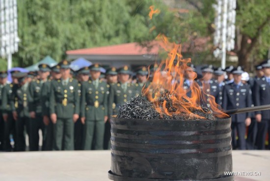 Drugs are burnt on International Day Against Drug Abuse and Illicit Trafficking in Qamdo, southwest China's Tibet Autonomous Region, June 26, 2014. 