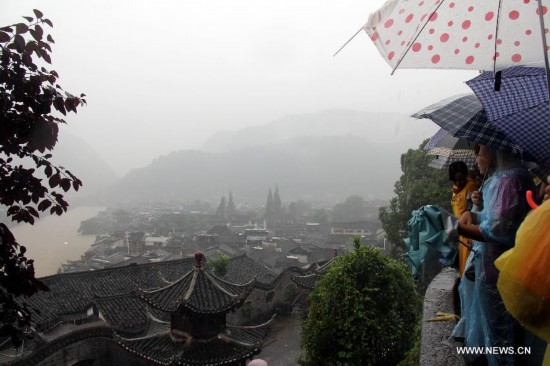 More than 120,000 locals and tourists have been evacuated since Monday night as record downpours hit Fenghuang County, a tourist destination renowned for its ancient town. 