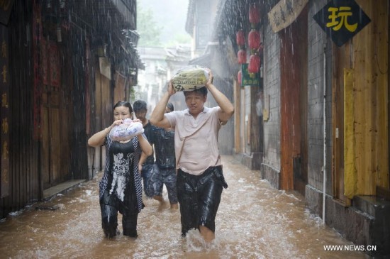 More than 120,000 locals and tourists have been evacuated since Monday night as record downpours hit Fenghuang County, a tourist destination renowned for its ancient town. 