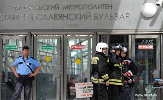 Rescuers and repair personnel work outside the Slavyanski Bulvar subway station in Moscow, capital of Russia, on July 15, 2014. At least 16 people have been confirmed dead after a metro train derailed in Moscow during the morning rush hour on Tuesday, Russian Emergency Situations Minister Vladimir Puchkov said.