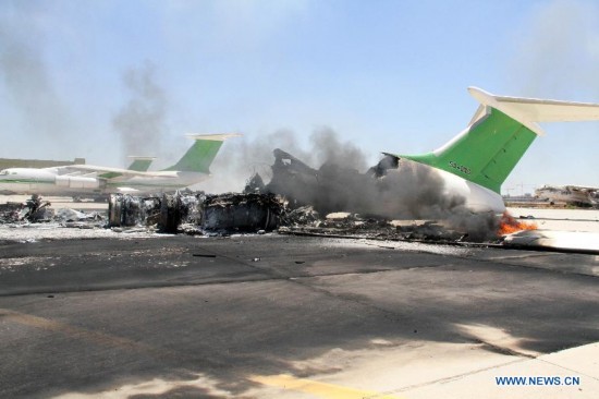 The photo taken on July 16, 2014 shows the ruin of a destroyed plane in Tripoli International Airport, in Libya. 