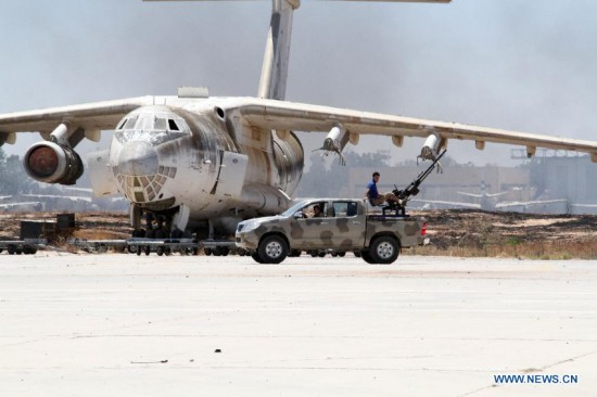 Militiamen in an armed vehicle patrols in Tripoli International Airport, in Libya, on July 16, 2014. 