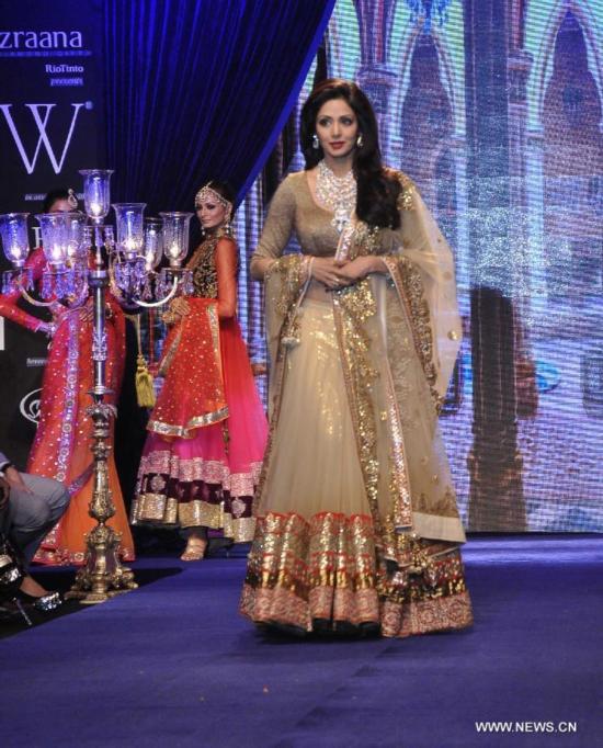 Models display the collection of jewellery designer Vijay Golecha at India International Jewellery Week 2014 in Mumbai, India, July 16, 2014.