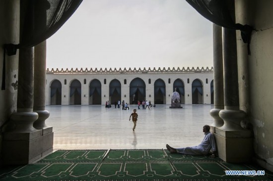 An Egyptian boy runs towards his father inside a mosque during the fasting hours in a Ramadan afternoon in Cairo July 7, 2014.