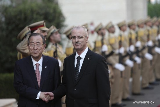 United Nations Secretary General Ban Ki-Moon (L) is welcomed by Palestinian Prime Minister Rami Hamdallah in the west bank city of Ramallah on July 22, 2014. 