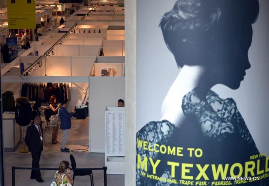 People visit the China Textile and Apparel Trade Show and the Home Textiles Fabric Sourcing Expo in New York, the United States, July 22, 2014.