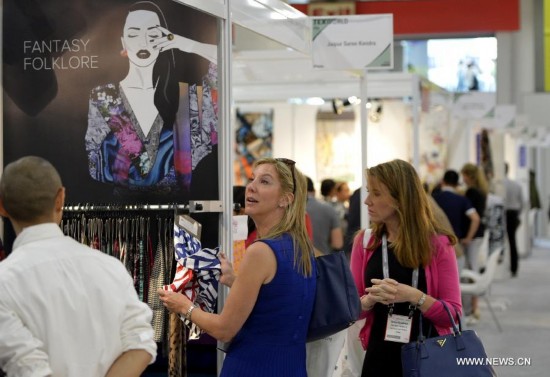 People visit the China Textile and Apparel Trade Show and the Home Textiles Fabric Sourcing Expo in New York, the United States, July 22, 2014.