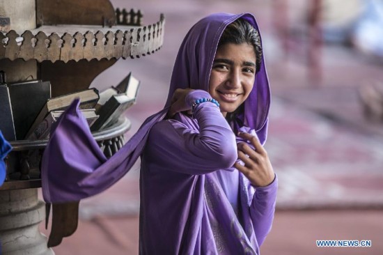 An Egyptian girl looks on inside a mosque during the fasting hours in a Ramadan afternoon in Cairo June 29, 2014.