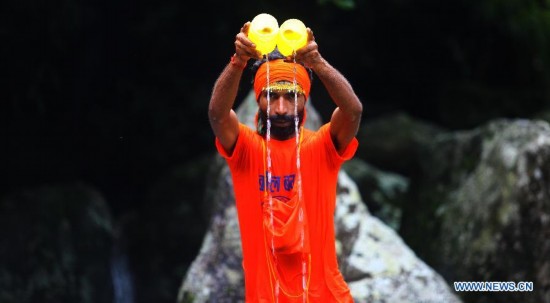 Hindu devotees walk towards the Pashupatinath Temple from Sundarijal in Kathmandu, Nepal, on July 28, 2014. 