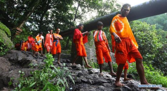 Hindu devotees walk towards the Pashupatinath Temple from Sundarijal in Kathmandu, Nepal, on July 28, 2014. 