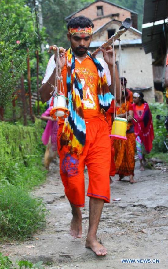 Hindu devotees walk towards the Pashupatinath Temple from Sundarijal in Kathmandu, Nepal, on July 28, 2014. 