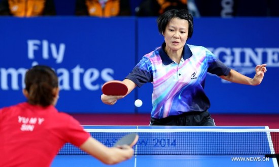 Ng Sock Khim of Malaysia competes during the women's team final of table tennis against Yu Mengyu of Singapore at the 2014 Glasgow Commonwealth Games 