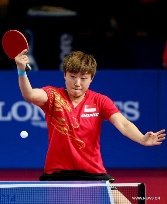 Feng Tianwei of Singapore competes during the women's team final of table tennis against Malaysia's Beh Lee Wei at the 2014 Glasgow Commonwealth Games 