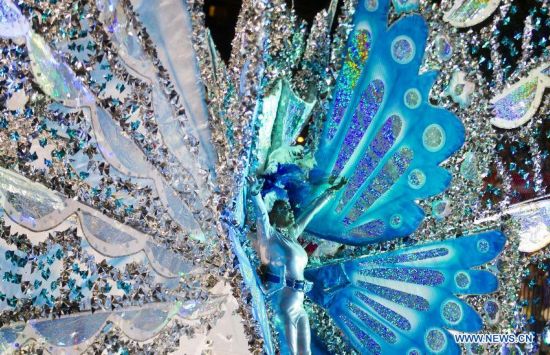 A dressed up competitor perfroms with her float during the King and Queen Competition and Show of the 47th Toronto Caribbean Carnival in Toronto, Canada, July 31, 2014.