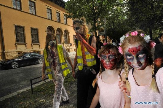 People dressed as zombies take part in a Zombie Walk in Stockholm, Sweden, on Aug.16, 2014.