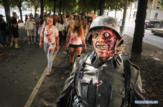 People dressed as zombies take part in a Zombie Walk in Stockholm, Sweden, on Aug.16, 2014.