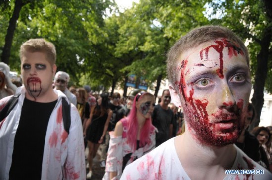 People dressed as zombies take part in a Zombie Walk in Stockholm, Sweden, on Aug.16, 2014.