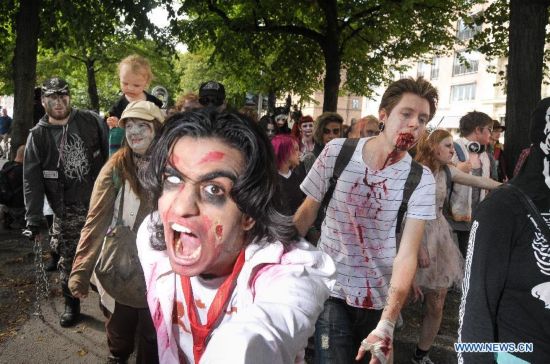 People dressed as zombies take part in a Zombie Walk in Stockholm, Sweden, on Aug.16, 2014.