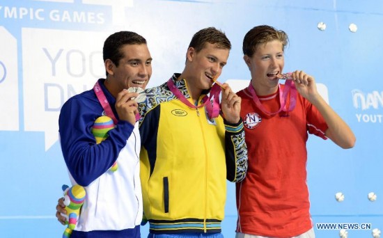 Gold medalist Mykhailo Romanchuk of Ukraine(C), silver medalist Maecelo Alberto Acosta of El Salvador(L) and bronze medalist Henrik Christiansen of Norway pose on the podium during the awarding ceremony of Men's 400m Freestyle of Nanjing 2014 Youth Olympic Games