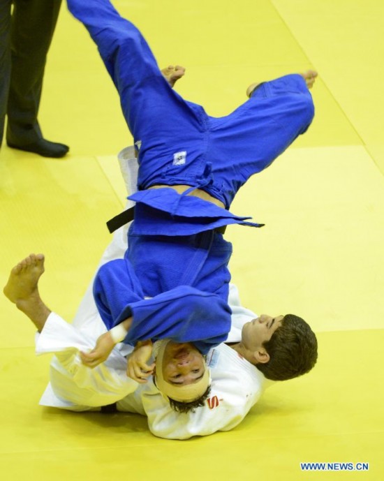 Sukhrob Tursunov of Uzbekistan(Bottom) competes during Men -66 kg of Judo event of Nanjing 2014 Youth Olympic Games