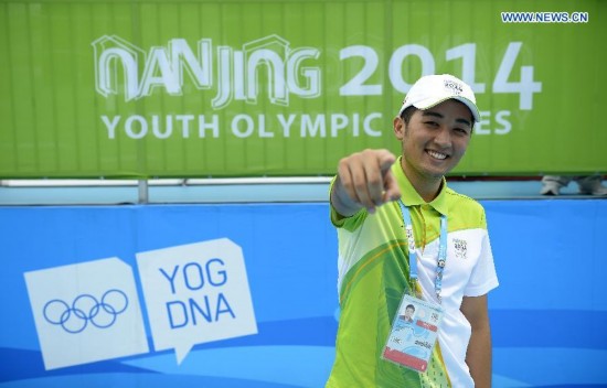 Medeu Askhatuly poses for a photo out of his office at the cycling venue during Nanjing 2014 Youth Olympic Games on Aug. 17, 2014. 