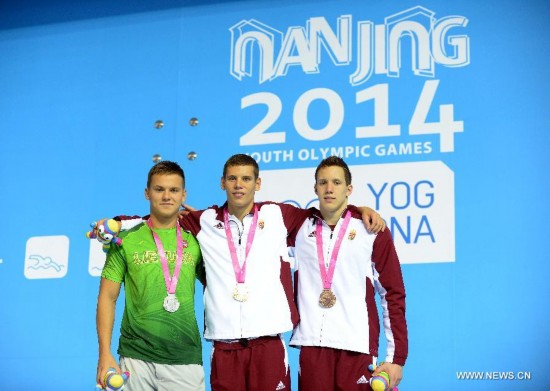 Gold medalist Benjamin Gratz (C) of Hungary, silver medalist Povilas Strazdas (L) of Lithuania and bronze medalist Norbert Szabo of Hungary pose on the podium after the men's 200m individual medley swimming event of Nanjing 2014 Youth Olympic Games