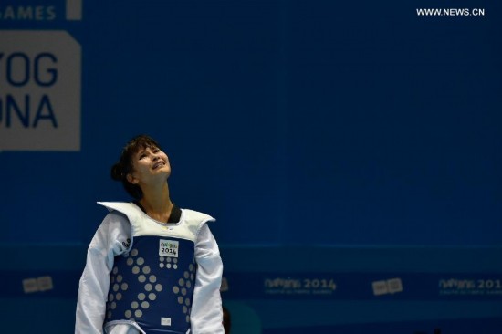 Abdullaeva Umida of Uzbekistan reacts after women +63kg final of taekwondo at the Nanjing 2014 Youth Olympic Games in Nanjing, east China's Jiangsu Province, Aug. 21, 2014.