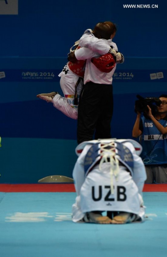 Abdullaeva Umida (F) of Uzbekistan reacts after women +63kg final of taekwondo at the Nanjing 2014 Youth Olympic Games in Nanjing, east China's Jiangsu Province, Aug. 21, 2014.