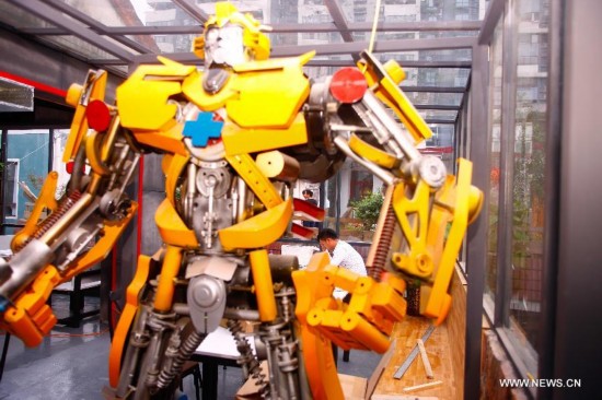 A robot model is seen at the Chilanqiao cultural block on Shuguangbei Street in Heifei, capital of east China's Anhui Province, Aug. 27, 2014. The cultural block, used to be a hub for junk dealers, has become a favorite destination for artists and culture lovers with its bookstores, galleries, bars and coffee houses and hostels after its reconstruction starting in 2012. (Xinhua/Zhu Weixi)