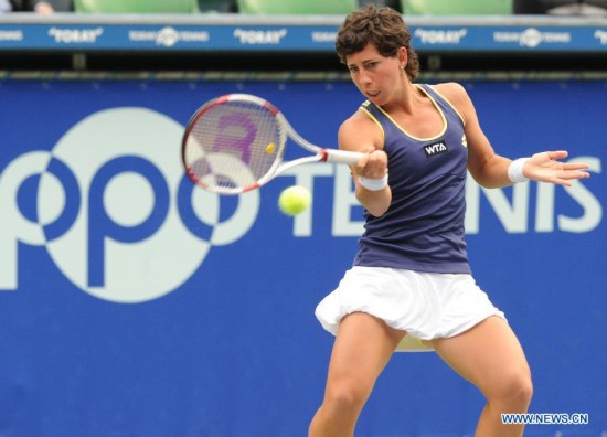 Carla Suarez Navarro of Spain hits a return against Caroline Wozniacki of Denmark during the third round match at the Toray Pan Pacific Open tournament in Tokyo, Japan, Sept. 19, 2014. 