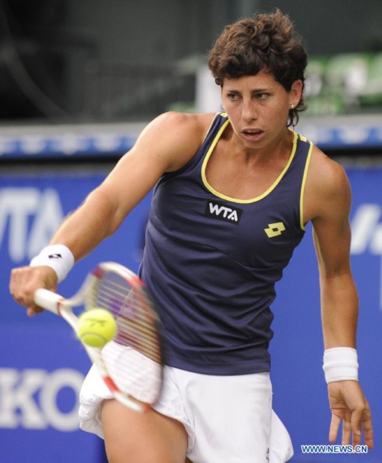 Carla Suarez Navarro of Spain hits a return against Caroline Wozniacki of Denmark during the third round match at the Toray Pan Pacific Open tournament in Tokyo, Japan, Sept. 19, 2014. 