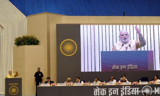 Indian Prime Minister Narendra Modi (L) addresses business leaders from India and abroad during the launch of his 'Make in India' initiative prior to his scheduled departure to the United States in New Delhi, India, Sept. 25, 2014. 