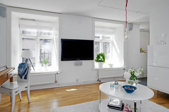 客厅里没有设计一个电视柜,而是将电视挂在两扇窗户中间的空白处