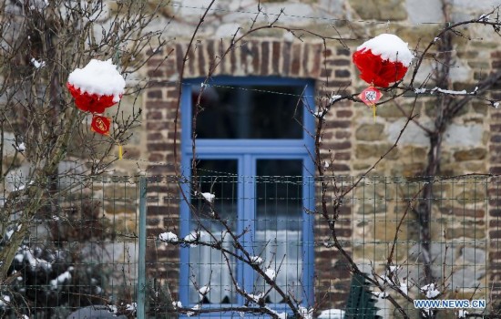 A house is decorated with Chinese lanterns during the Art Biennale in Theux in eastern Belgium on Jan. 24, 2015. 