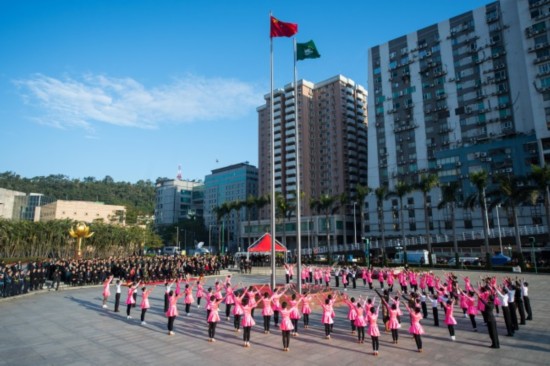 The government of Macao Special Administrative Region of the People's Republic of China holds a grand flag raising ceremony on Wednesday to celebrate the 18th anniversary of its return to the motherland at Golden Lotus Square. [Photo: China Plus/ Liu Libin]