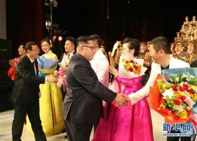 Kim Jong Un, chairman of the Workers' Party of Korea (WPK) and chairman of the State Affairs Commission of the Democratic People's Republic of Korea (DPRK), shakes hands with artists from China and the DPRK following a joint performance in Pyongyang on Saturday, November 3. [Photo: Xinhua]