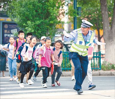 侍东亮护著孩子们过马路.