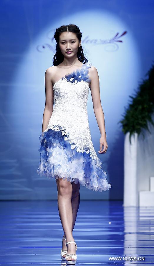 A model presents a wedding gown designed by Ren Chunhua during China Fashion Week in Beijing, capital of China, Oct. 26, 2014. 