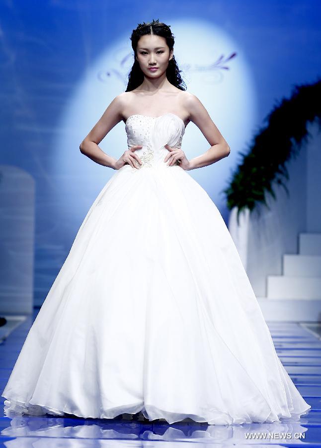 A model presents a wedding gown designed by Ren Chunhua during China Fashion Week in Beijing, capital of China, Oct. 26, 2014.