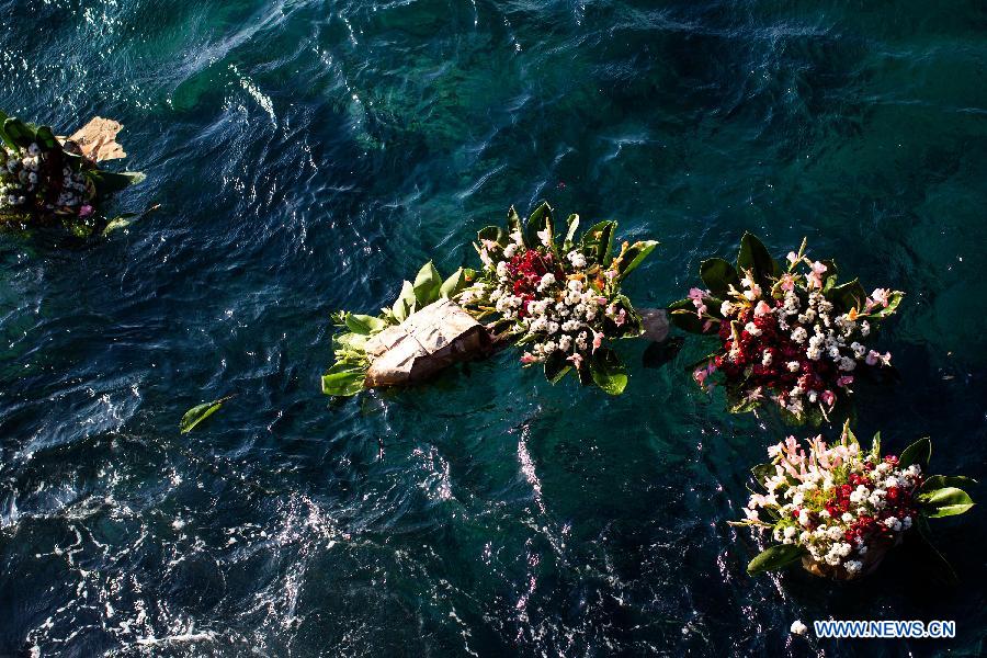 Flowers float on the sea during a ceremony commemorating Camilo Cienfuegos in Havana, capital of Cuba, on Oct. 28, 2014.