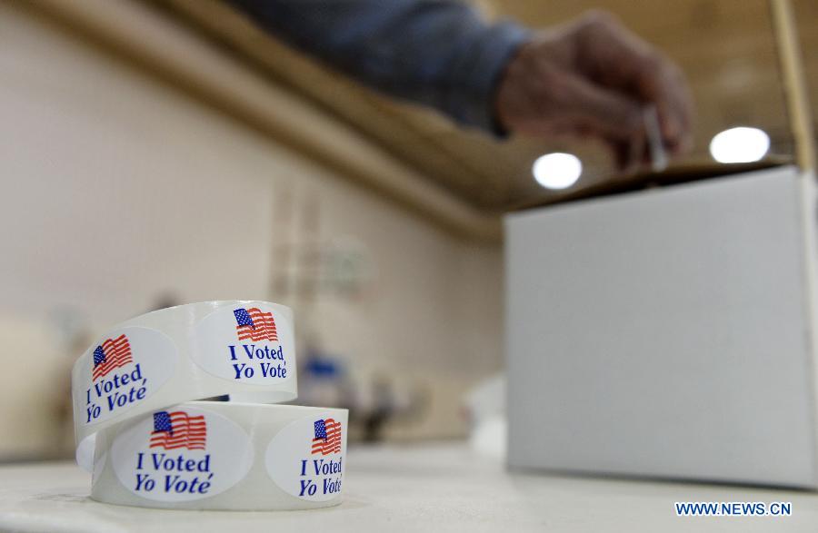 A man returns his voting card after casting his votes during the U.S. Midterm Elections at a polling place in Rockville, Maryland, the United States, on Nov. 4, 2014.