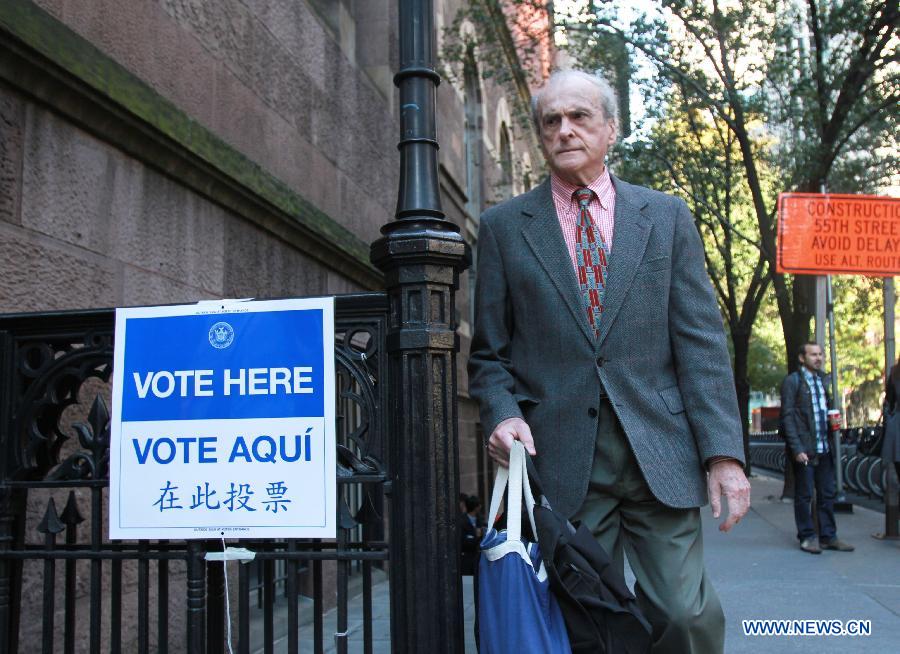 A registered elector leaves a polling station after casting his vote during the Midterm Elections in New York, the United States, on Nov. 4, 2014. 