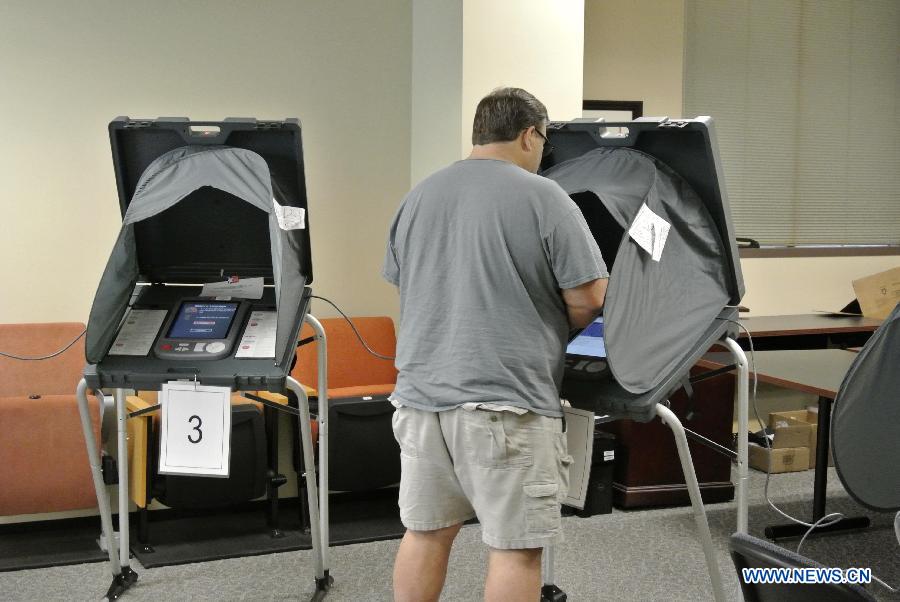 A man votes at a polling station in Sugar Land, the United States, Nov. 4, 2014. 