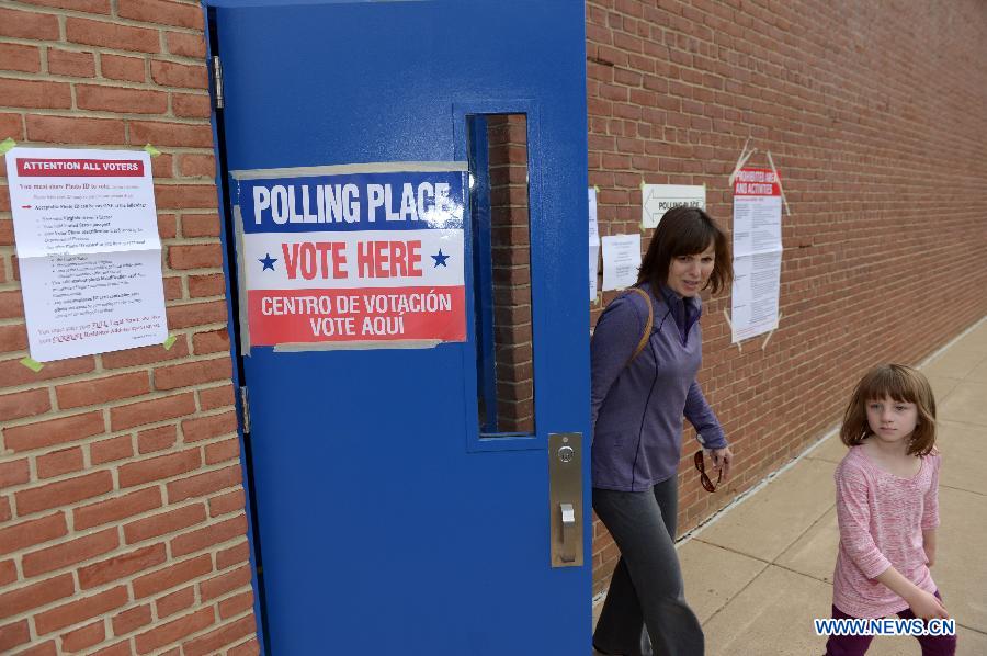 A woman leaves after casting her vote during the U.S. Midterm Elections is seen at a polling place in Rockville, Maryland, the United States, on Nov. 4, 2014. 