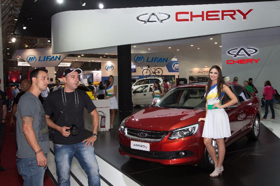 Visitors examines an 'Arrizo7' designed by China's Chery at the Sao Paulo Auto Exhibition in Sao Paulo, Brazil, Nov. 6, 2014. 