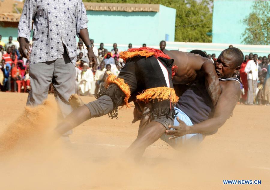 Nubian men wrestle during the annual harvest festival in Omdurman, Sudan, Nov. 8, 2014. Nubians gathered to celebrate the annual harvest festival in Omdurman on Saturday.