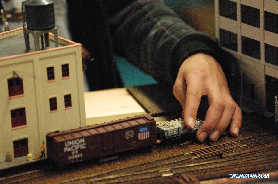 An exhibitor prepares model trains to run during the 32nd Model Railway Exhibition 'Trains 2014' in Burnaby, Canada, Nov. 8, 2014.