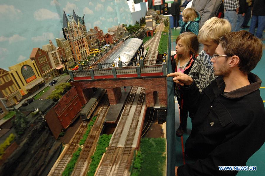 People watch model trains during the 32nd Model Railway Exhibition 'Trains 2014' in Burnaby, Canada, Nov. 8, 2014.